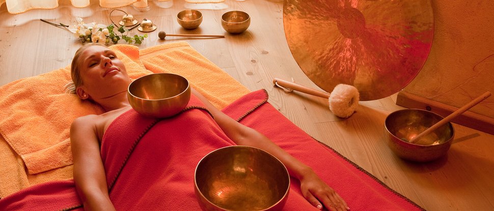 Current news and stories from Olang Woman relaxing during sound bowl therapy in peaceful room
