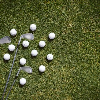 Golfclub Pustertal - Your golf course at Mt. Kronplatz Three golf clubs and several golf balls on grass
