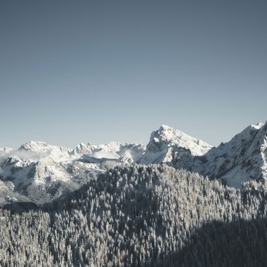 Winter hiking at Plan de Corones/Kronplatz Snow-covered mountains under a clear sky