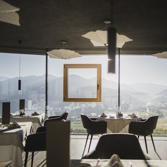 Bruneck: shopping & more Restaurant with panoramic view of mountains and valley in daylight