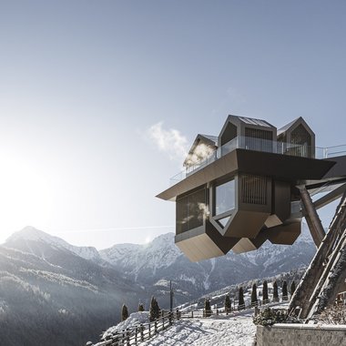 Awards & Press Modern hotel room with glass facade on snowy mountain slope