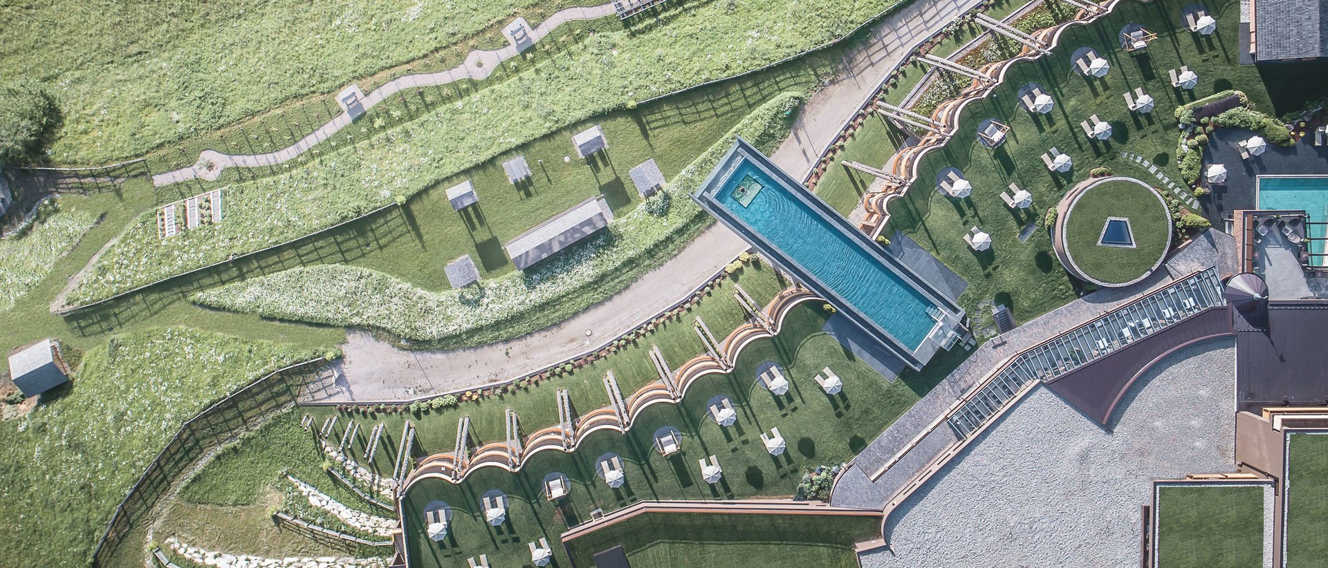 Our 5-star hotel in Italy between heaven and earth Aerial view of modern hotel with pool and green landscape