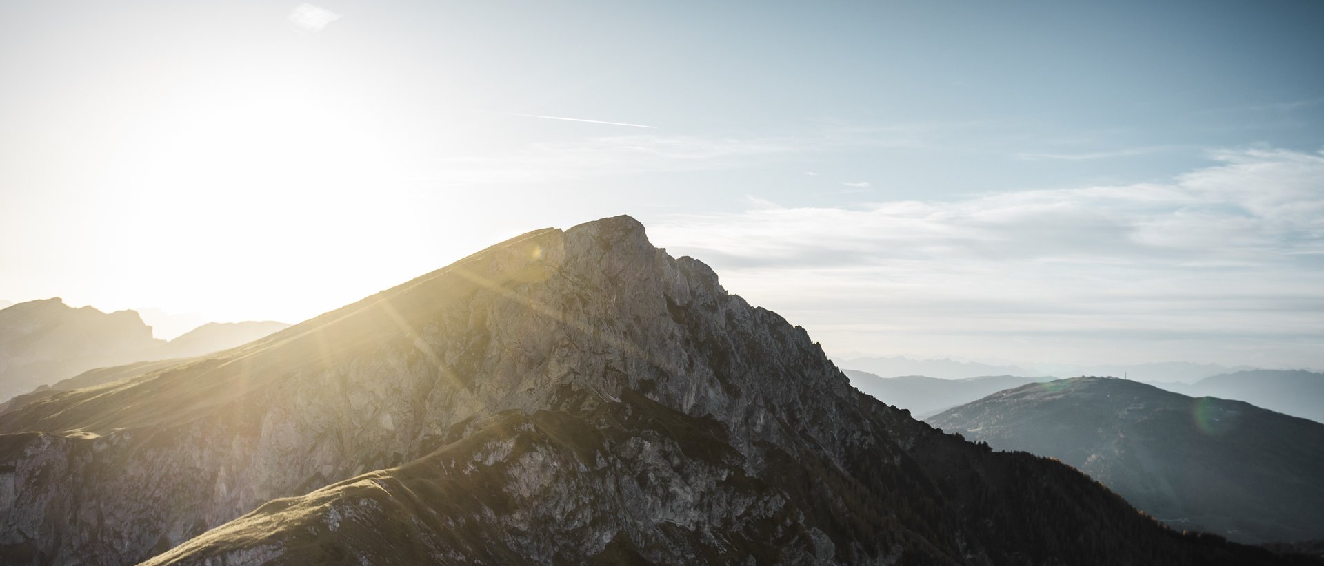 Active holidays in South Tyrol: a great experience Sunrise over rocky mountain peaks with blue sky