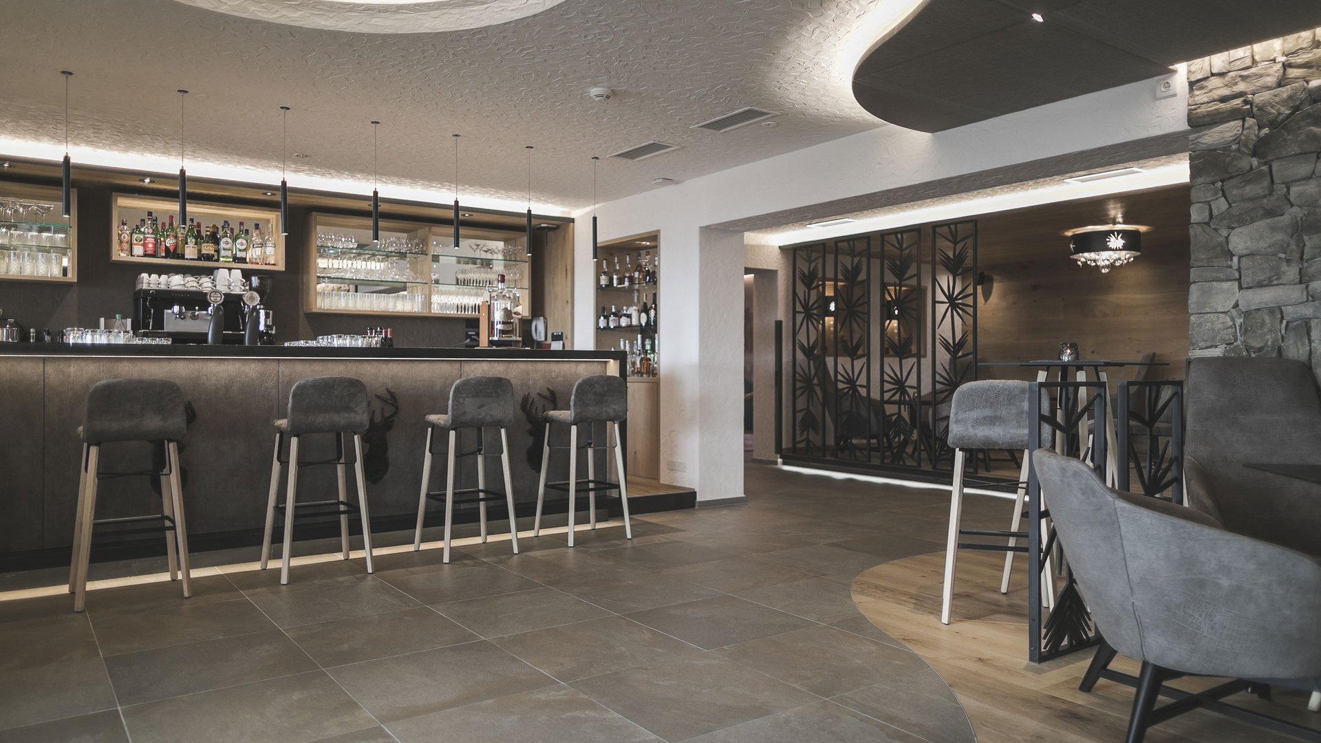 A place to enjoy Modern bar area with high stools and stylish lighting
